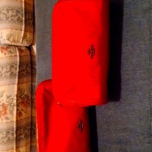2 red Coach cosmetic  bags